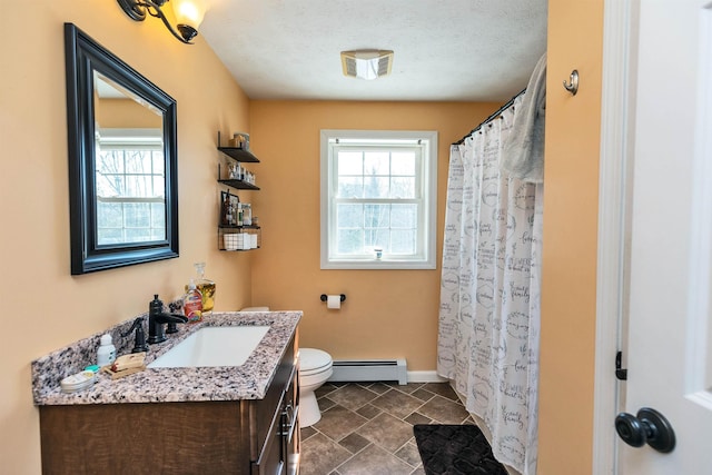 bathroom featuring a healthy amount of sunlight, toilet, vanity, and a baseboard radiator