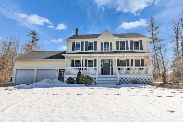 colonial house with an attached garage, covered porch, and a chimney