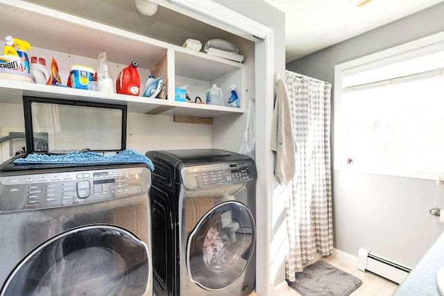 laundry area with a baseboard heating unit, baseboards, washing machine and dryer, and laundry area