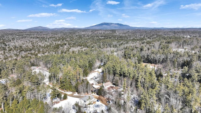 drone / aerial view featuring a view of trees and a mountain view