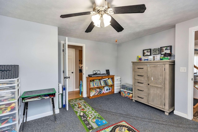 rec room featuring ceiling fan, baseboards, and carpet