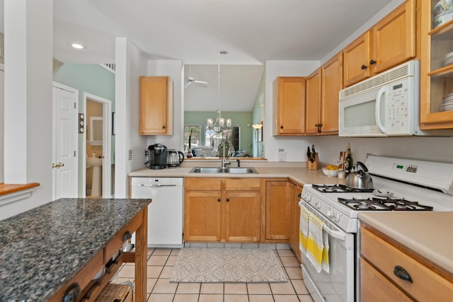 kitchen with ceiling fan with notable chandelier, a sink, white appliances, light tile patterned floors, and glass insert cabinets