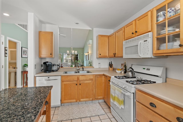 kitchen featuring white appliances, a notable chandelier, glass insert cabinets, and a sink