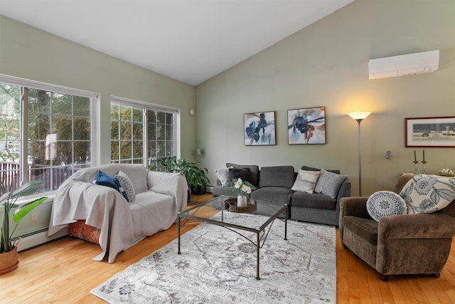 living area featuring high vaulted ceiling, baseboard heating, an AC wall unit, and wood-type flooring