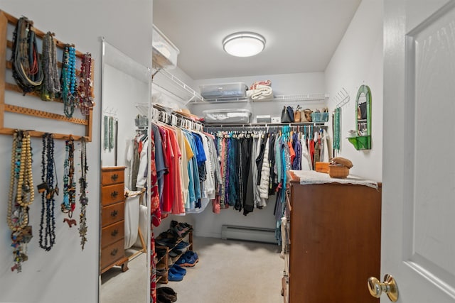 spacious closet featuring baseboard heating and carpet