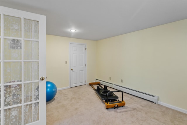 exercise area featuring baseboards, baseboard heating, and carpet floors