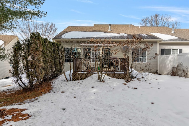 snow covered property with fence and a wooden deck