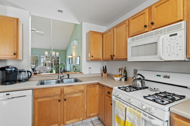 kitchen featuring vaulted ceiling, white appliances, light countertops, and a sink