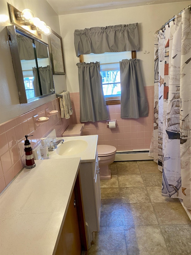 full bathroom with toilet, tile walls, wainscoting, a baseboard radiator, and vanity