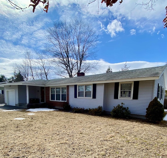 single story home featuring a chimney and an attached garage