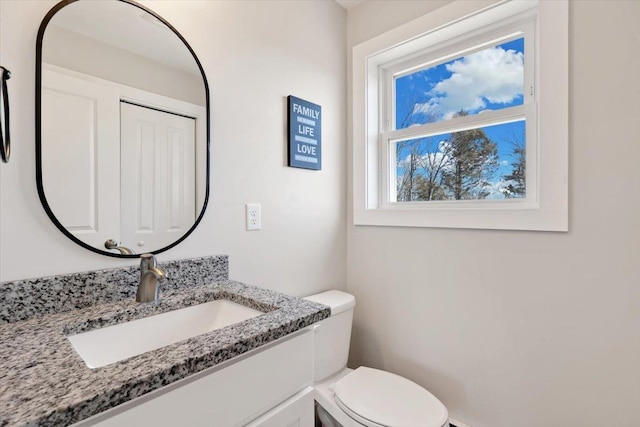 bathroom featuring vanity and toilet