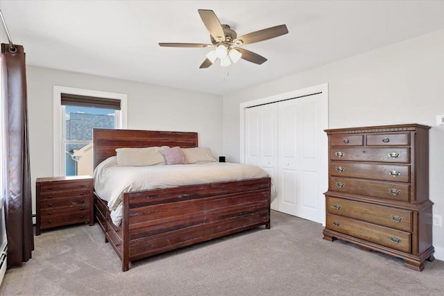 bedroom featuring a closet, light colored carpet, and a ceiling fan