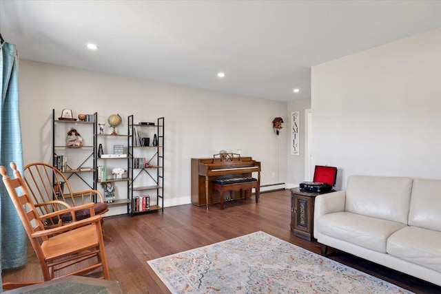 living room featuring a baseboard heating unit, recessed lighting, wood finished floors, and baseboards