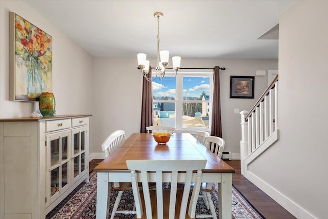 dining room with a notable chandelier, stairs, baseboards, baseboard heating, and dark wood-style flooring