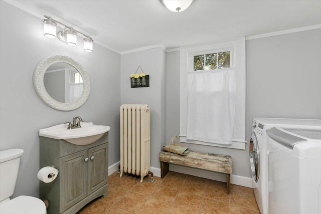 bathroom with toilet, washer and dryer, radiator, crown molding, and vanity