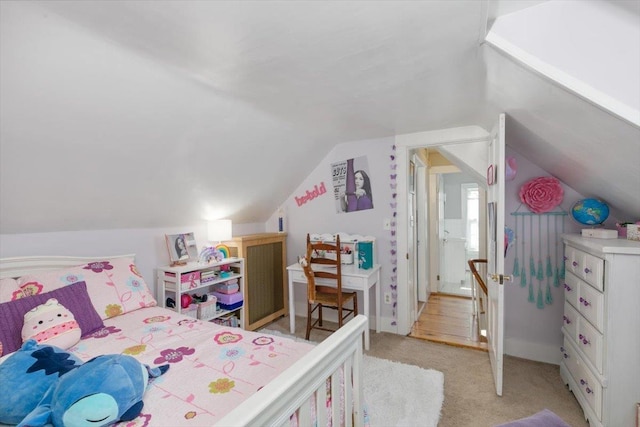 bedroom featuring light carpet and vaulted ceiling