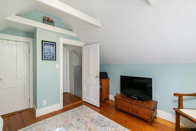 additional living space featuring lofted ceiling, wood finished floors, and baseboards