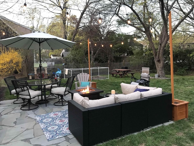 view of patio with an outdoor living space with a fire pit, outdoor dining space, and fence