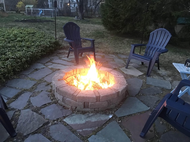 view of patio / terrace with a fire pit and fence