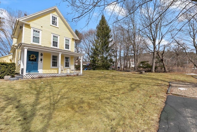 view of front of home with a porch and a front yard