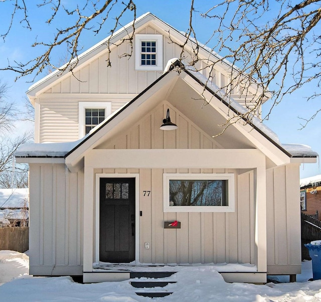 view of front of house with board and batten siding and fence