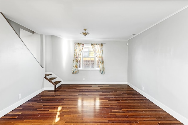 unfurnished room featuring visible vents, baseboards, stairs, ornamental molding, and wood finished floors