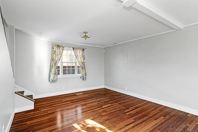 empty room with visible vents, crown molding, baseboards, stairway, and wood-type flooring