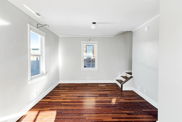 unfurnished room featuring plenty of natural light, stairway, visible vents, and wood finished floors