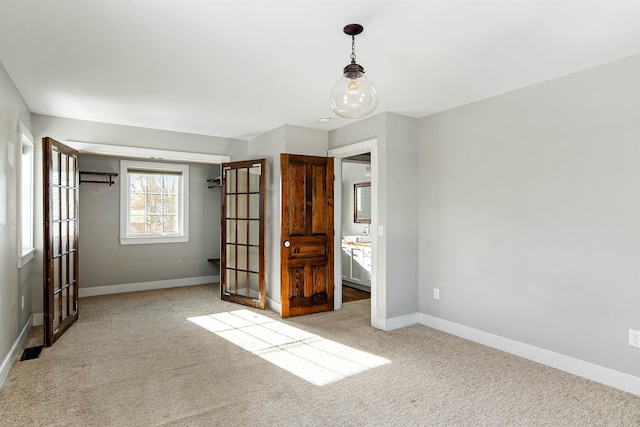 unfurnished bedroom featuring carpet flooring, baseboards, and a sink