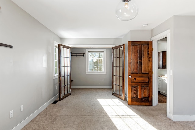 unfurnished bedroom with french doors, baseboards, and carpet floors