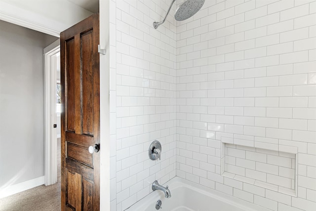 bathroom with baseboards and  shower combination