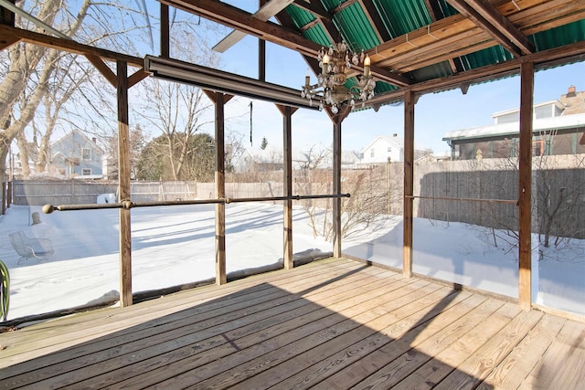 unfurnished sunroom featuring an inviting chandelier