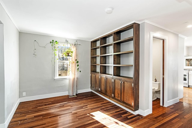 interior space with baseboards, dark wood finished floors, and ornamental molding