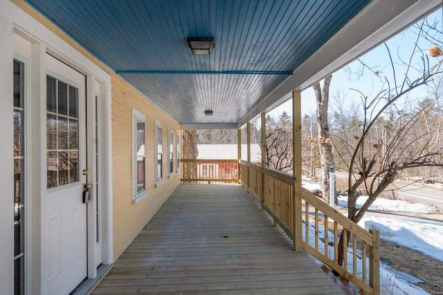 snow covered deck with a porch