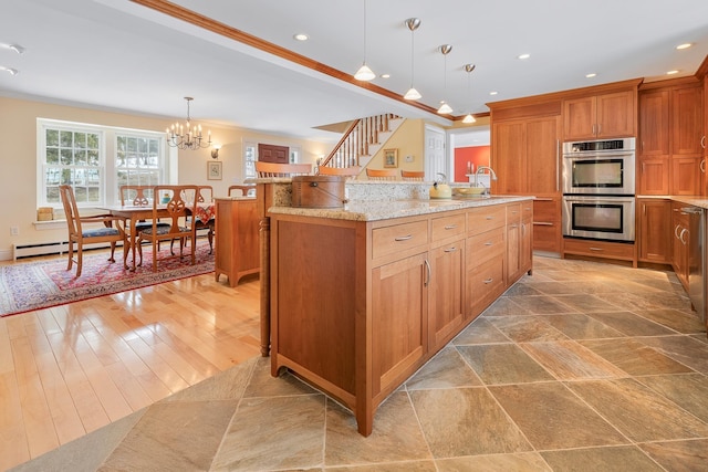 kitchen featuring crown molding, pendant lighting, brown cabinets, and stainless steel double oven