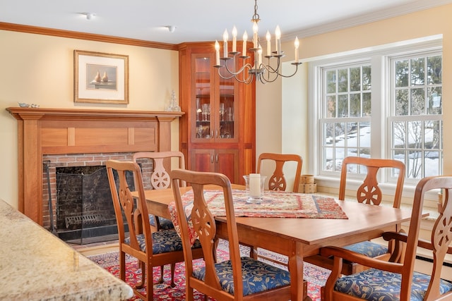 dining area with crown molding, a notable chandelier, and a fireplace with flush hearth