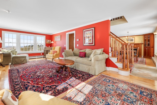 living area featuring ornamental molding, wood finished floors, stairway, an inviting chandelier, and a baseboard radiator