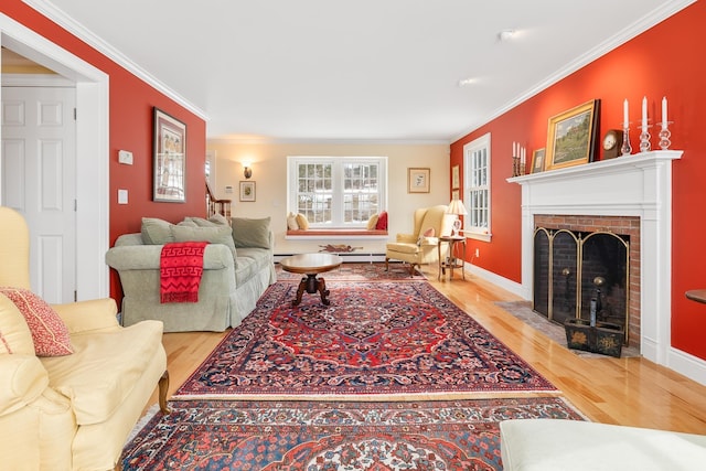 living area with a fireplace, wood finished floors, baseboards, and ornamental molding