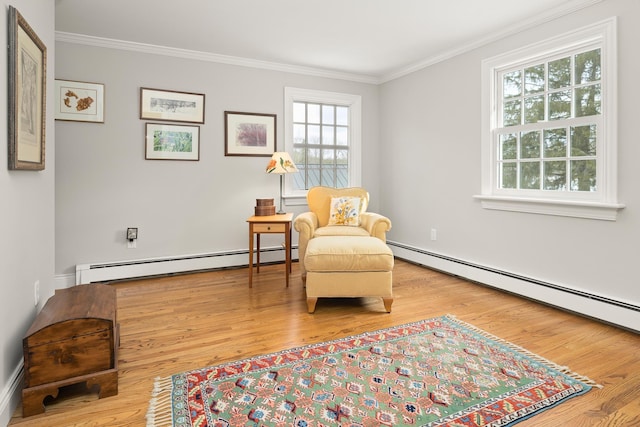 living area with a baseboard heating unit, wood finished floors, and ornamental molding