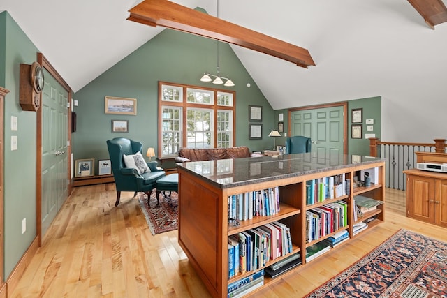 office space with beam ceiling, light wood-type flooring, and high vaulted ceiling