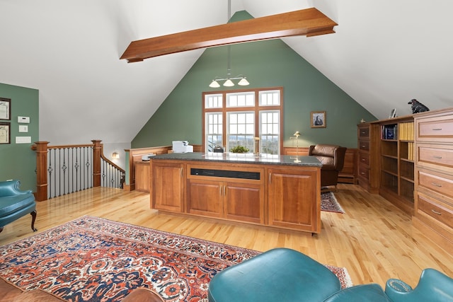 office space featuring light wood-style flooring and lofted ceiling with beams