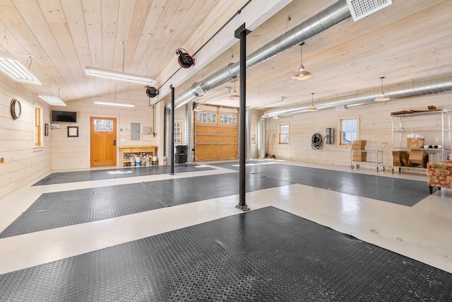 misc room featuring visible vents, finished concrete floors, wood walls, lofted ceiling, and wooden ceiling