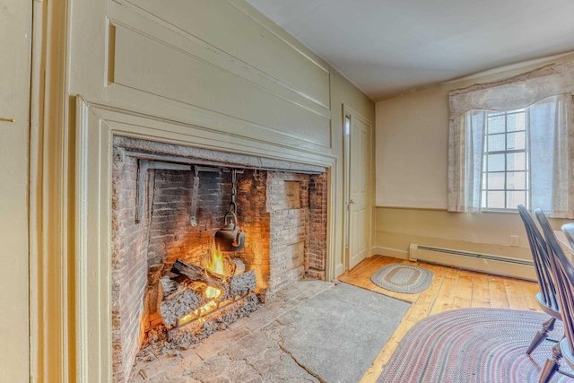 interior space featuring wood finished floors and a baseboard radiator