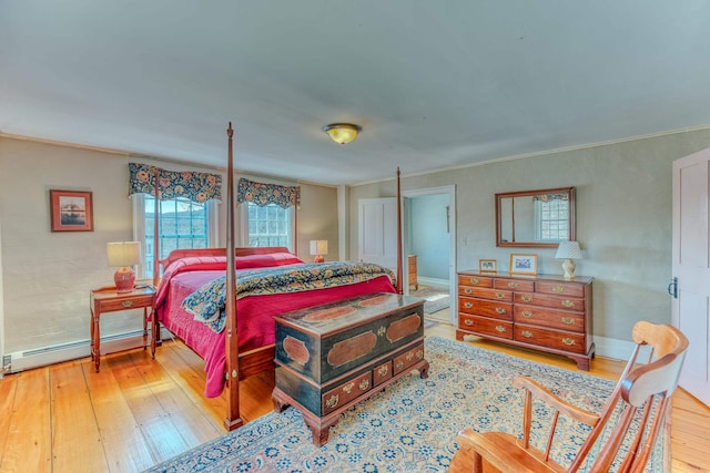 bedroom with ornamental molding, a baseboard radiator, baseboards, and wood-type flooring