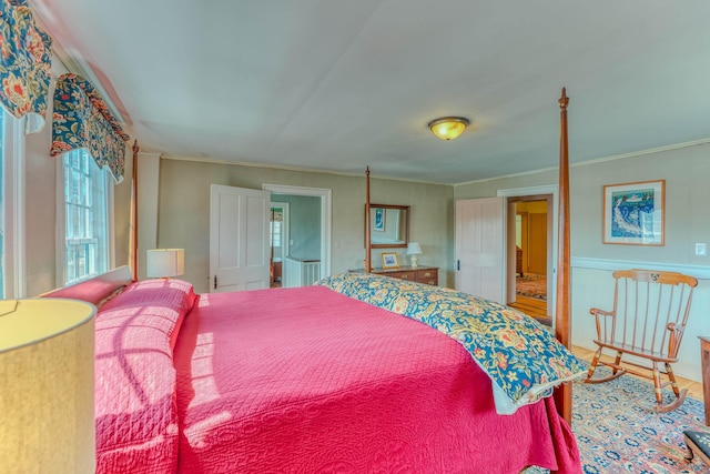 bedroom featuring crown molding and wood finished floors