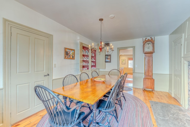 dining room featuring light wood-style floors and a chandelier