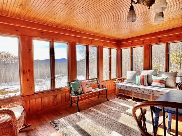 sunroom / solarium with a mountain view and wooden ceiling