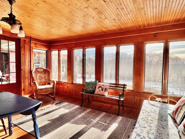 sunroom featuring wooden ceiling and a healthy amount of sunlight