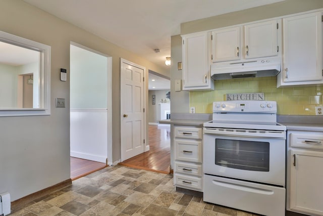 kitchen featuring under cabinet range hood, electric range, white cabinetry, and decorative backsplash