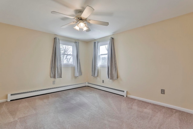 carpeted spare room with a baseboard radiator, baseboards, and ceiling fan